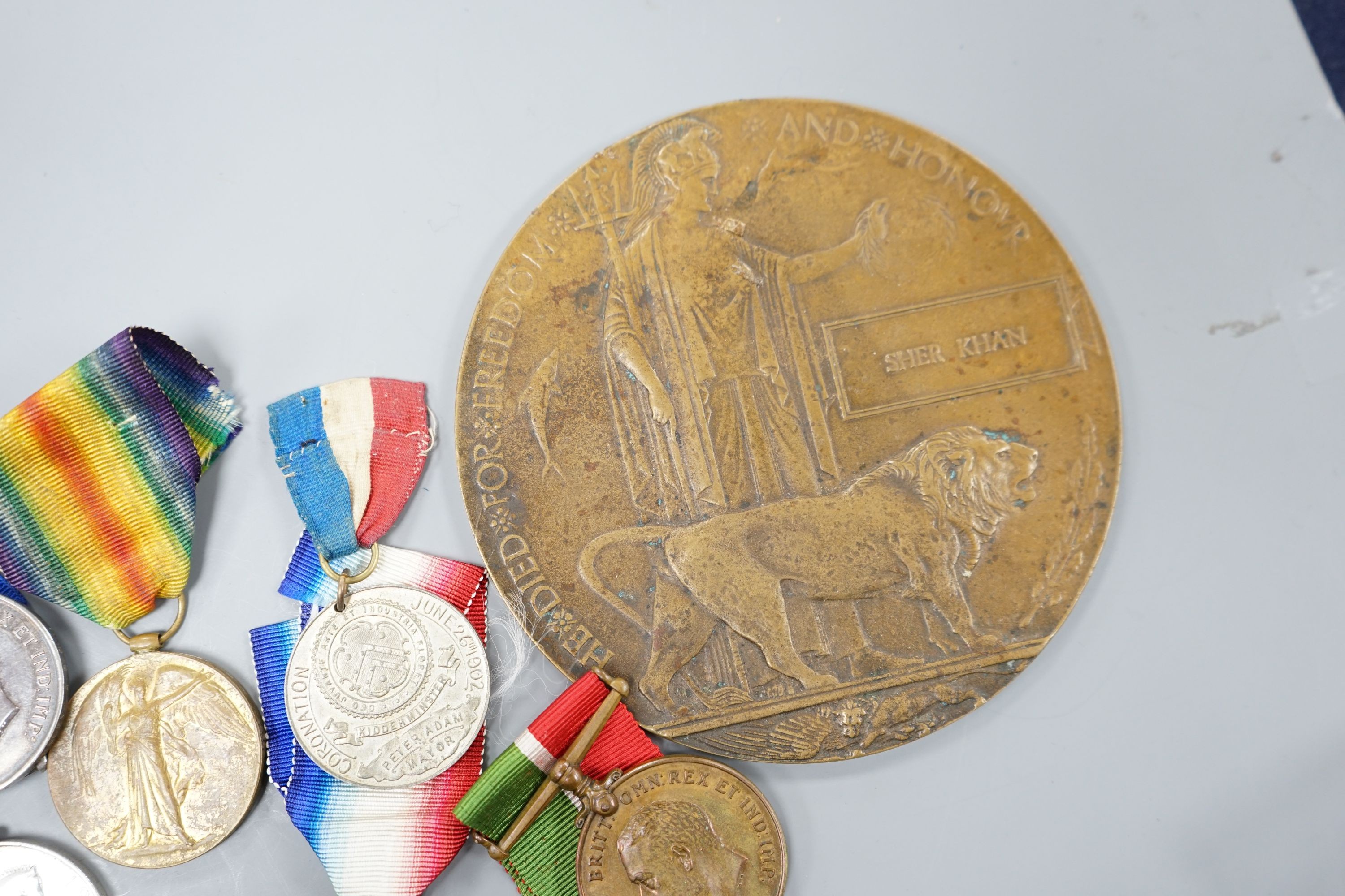 A collection of of odd WW1 medals to different recipients and a bronze death plaque to Shah Khan